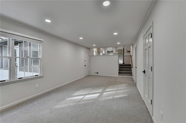 empty room featuring light carpet and ornamental molding