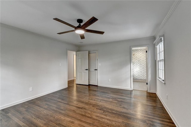 spare room with crown molding, dark hardwood / wood-style floors, and ceiling fan