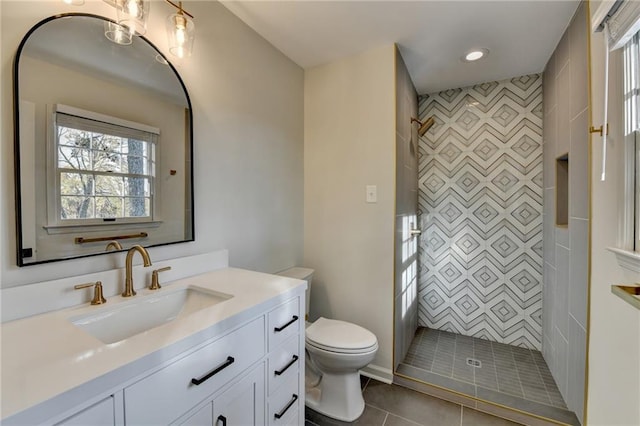 bathroom with vanity, toilet, a shower, and tile patterned floors