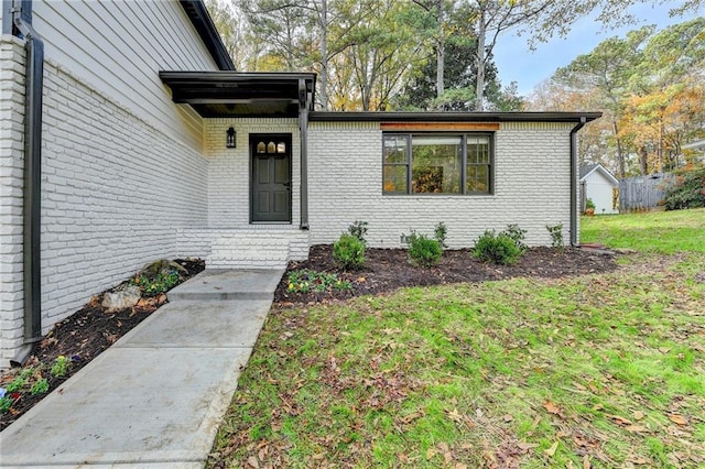 entrance to property with a lawn