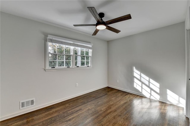 empty room featuring ceiling fan and dark hardwood / wood-style floors