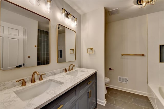 bathroom featuring a bathtub, toilet, tile patterned flooring, and vanity