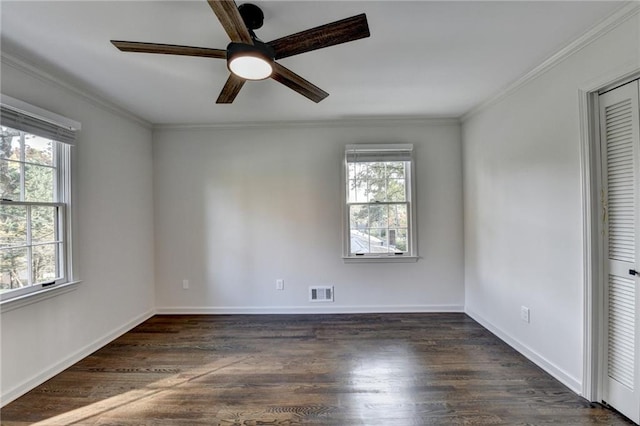 unfurnished bedroom featuring crown molding, a closet, ceiling fan, and dark hardwood / wood-style flooring