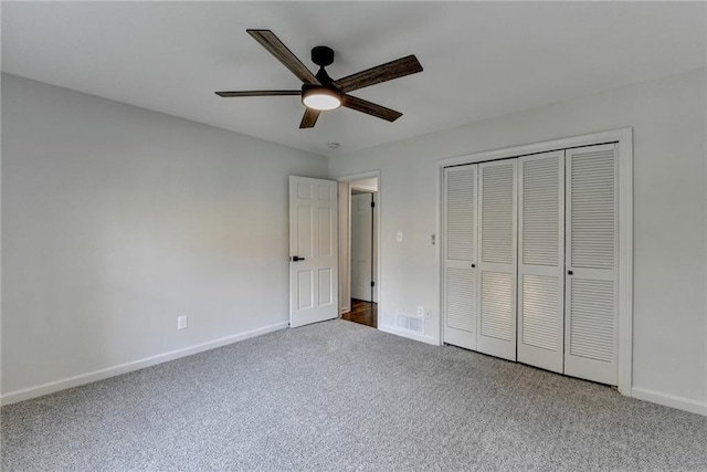 unfurnished bedroom with a closet, ceiling fan, and carpet flooring