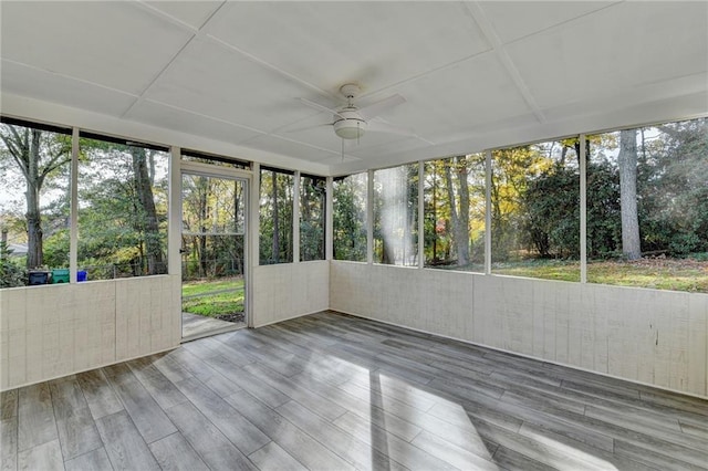 unfurnished sunroom with ceiling fan and a healthy amount of sunlight