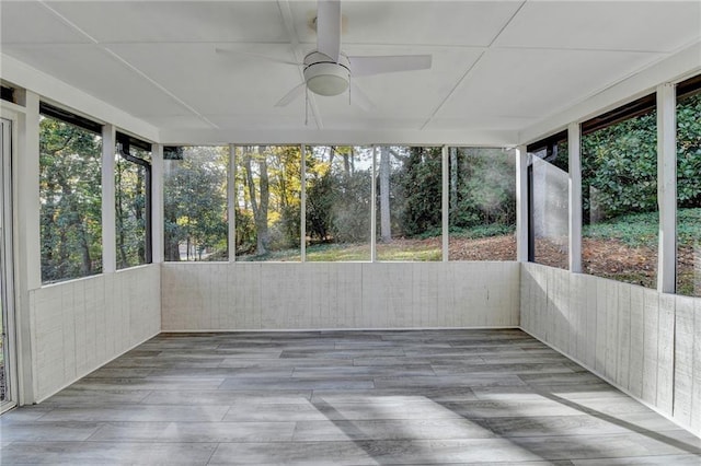 unfurnished sunroom with ceiling fan