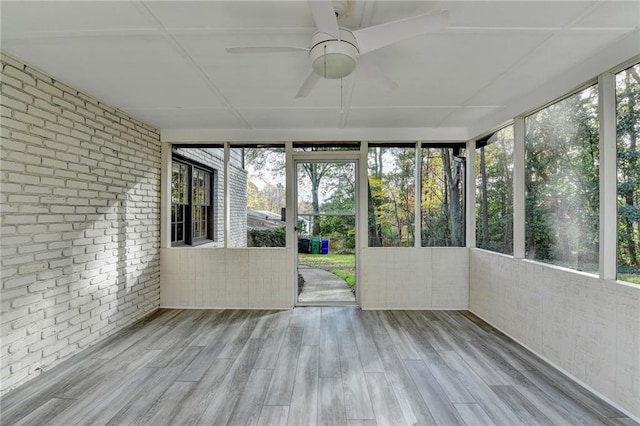 unfurnished sunroom with ceiling fan