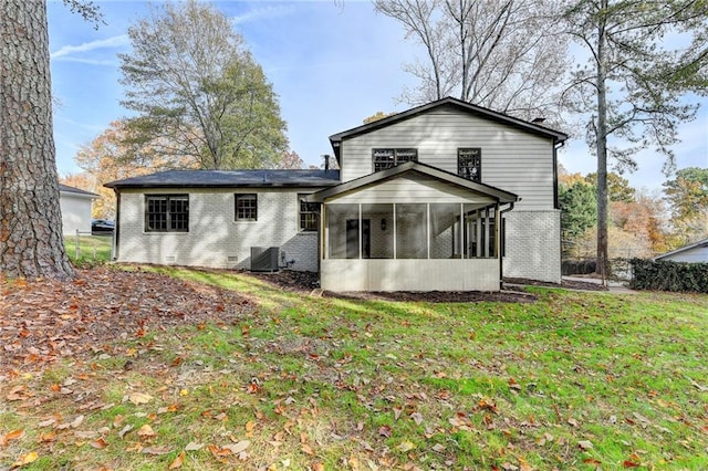 back of property featuring a sunroom, a yard, and central AC