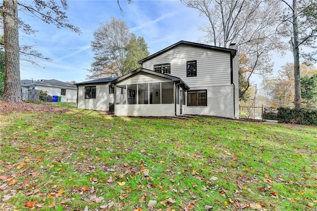 back of house featuring a sunroom and a yard