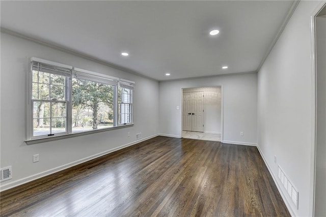 unfurnished room with ornamental molding and dark hardwood / wood-style flooring