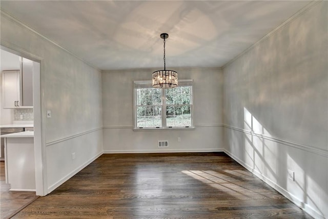 unfurnished dining area featuring dark wood-type flooring and a chandelier