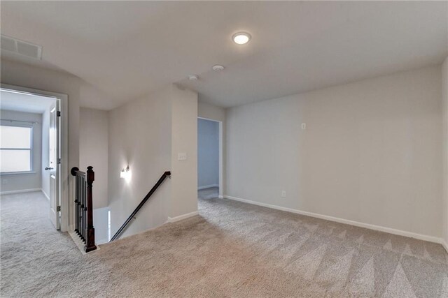 unfurnished bedroom with light carpet and a closet