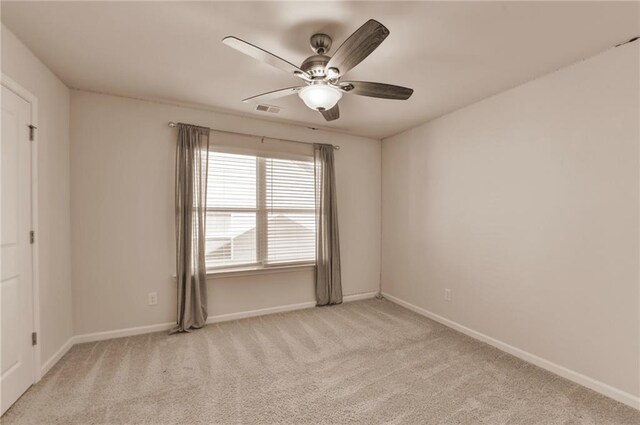 unfurnished bedroom featuring light colored carpet, ceiling fan, and a tray ceiling