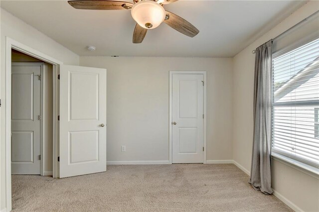 bathroom with vanity, tiled bath, and tile patterned flooring