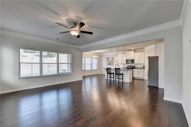 living room featuring ceiling fan, ornamental molding, and dark hardwood / wood-style flooring