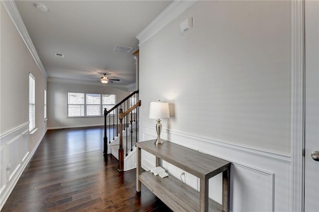 corridor featuring ornamental molding and dark wood-type flooring