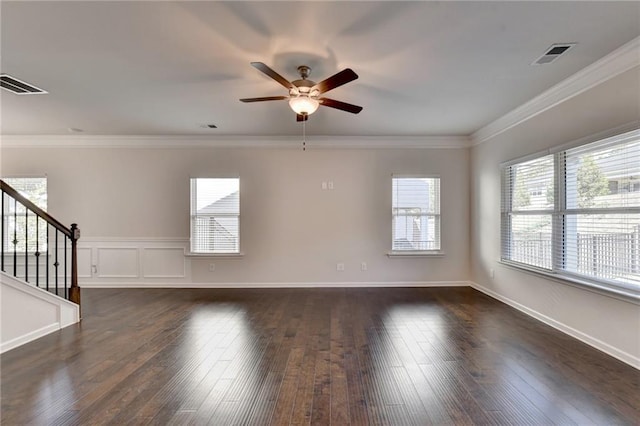 unfurnished room featuring ornamental molding, dark hardwood / wood-style floors, and a healthy amount of sunlight