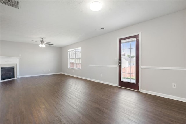 139 Palmetto St, Locust Grove, GA 30248 - unfurnished living room with ceiling fan, dark wood-type flooring, a fireplace, and baseboards