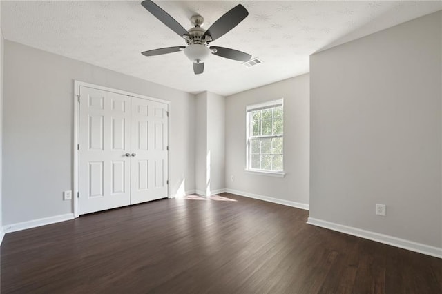139 Palmetto St, Locust Grove, GA 30248 - unfurnished bedroom with dark wood-type flooring, baseboards, a closet, and a ceiling fan