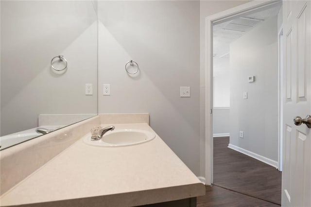 139 Palmetto St, Locust Grove, GA 30248 - bathroom featuring vanity, wood finished floors, and baseboards