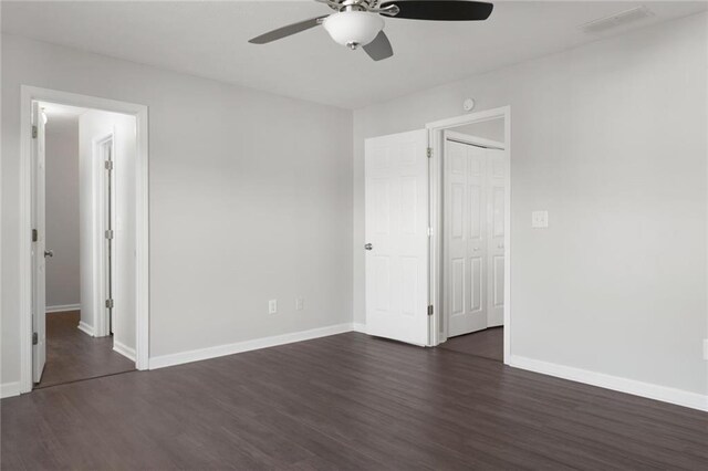 139 Palmetto St, Locust Grove, GA 30248 - unfurnished bedroom featuring dark wood-style floors, baseboards, and a ceiling fan