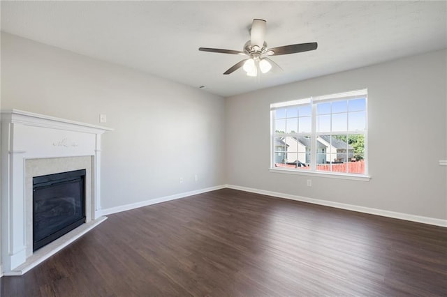 139 Palmetto St, Locust Grove, GA 30248 - unfurnished living room with dark wood-style flooring, baseboards, a glass covered fireplace, and ceiling fan