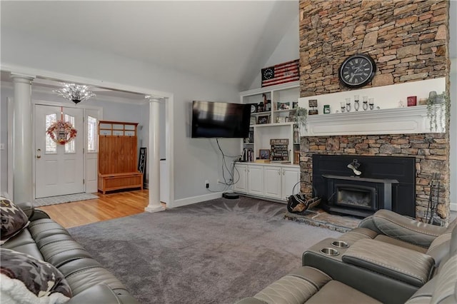 living room featuring ornate columns, carpet floors, high vaulted ceiling, a fireplace, and baseboards