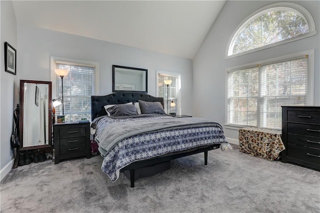 bedroom with carpet flooring, baseboards, and high vaulted ceiling
