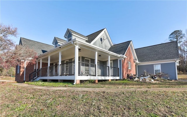 view of front of home featuring a front yard and a porch