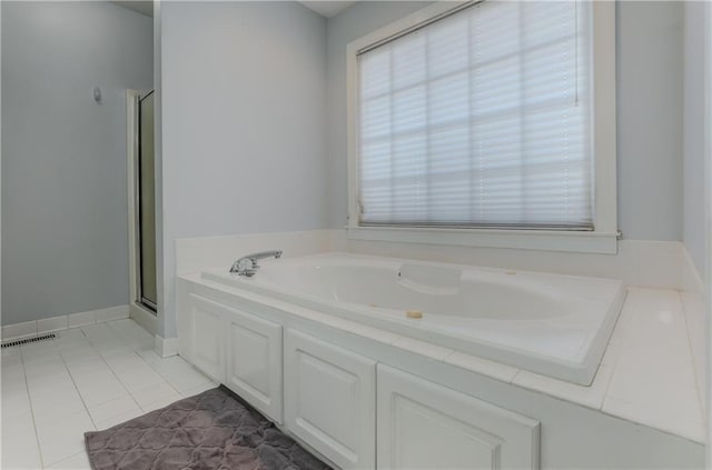 full bath with tile patterned floors, a stall shower, and a bath
