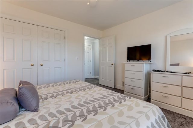 carpeted bedroom with a closet and baseboards