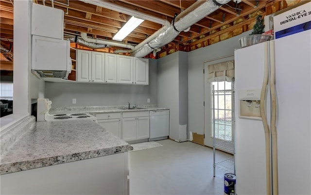 kitchen featuring white appliances, a sink, finished concrete floors, and white cabinets
