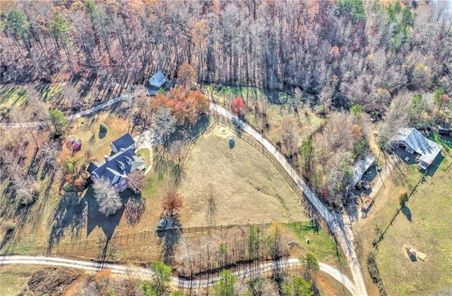 aerial view of property's location with a forest and rural landscape