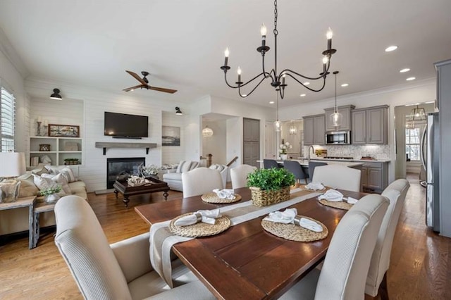 12603 Itaska Walk, Milton, GA 30004 - dining area featuring healthy amount of natural light, a ceiling fan, light wood-type flooring, a chandelier, and recessed lighting