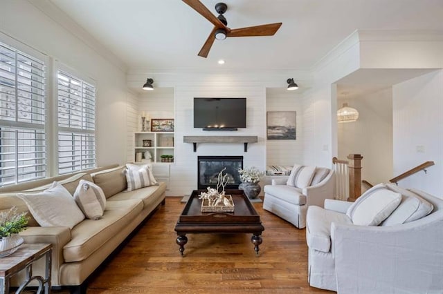 12603 Itaska Walk, Milton, GA 30004 - living area featuring a ceiling fan, wood finished floors, crown molding, a glass covered fireplace, and recessed lighting