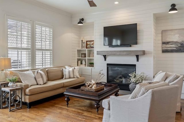 12603 Itaska Walk, Milton, GA 30004 - living room with wood finished floors, wood walls, ornamental molding, a large fireplace, and recessed lighting