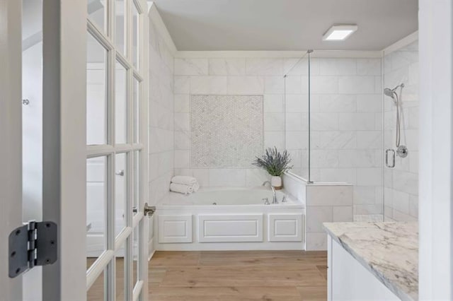 12603 Itaska Walk, Milton, GA 30004 - bathroom featuring a garden tub, a tile shower, wood finished floors, and vanity