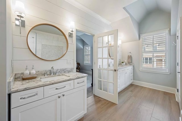 12603 Itaska Walk, Milton, GA 30004 - full bath with two vanities, plenty of natural light, wood finished floors, vaulted ceiling, and baseboards