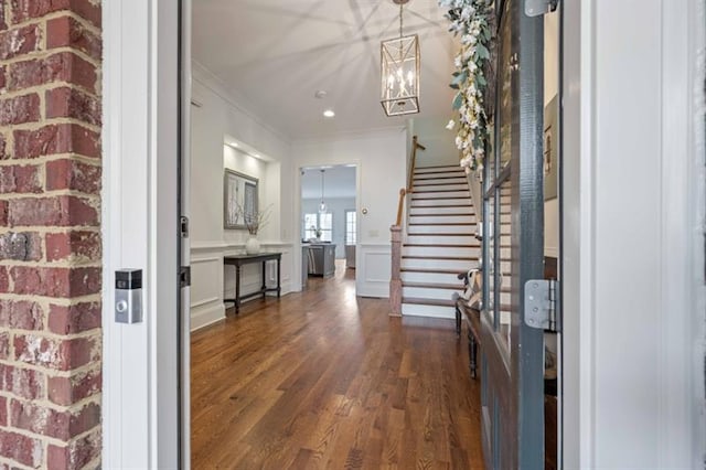 12603 Itaska Walk, Milton, GA 30004 - entryway featuring dark wood finished floors, stairway, crown molding, a chandelier, and a wainscoted wall