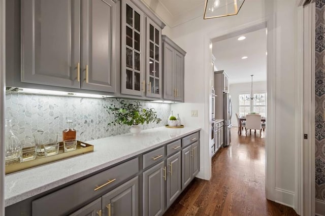 12603 Itaska Walk, Milton, GA 30004 - bar area with dark wood-style flooring, freestanding refrigerator, backsplash, recessed lighting, and crown molding