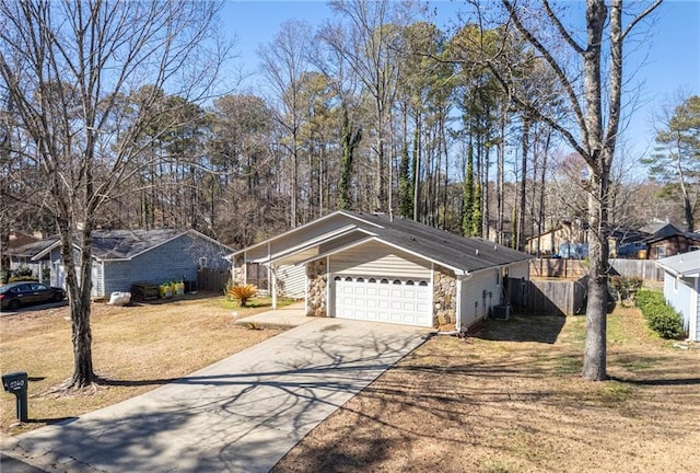 single story home featuring a front lawn, central AC, and a garage