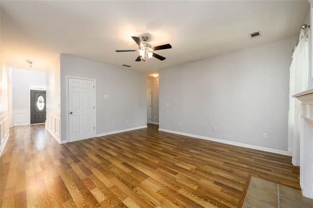 unfurnished living room with wood-type flooring and ceiling fan