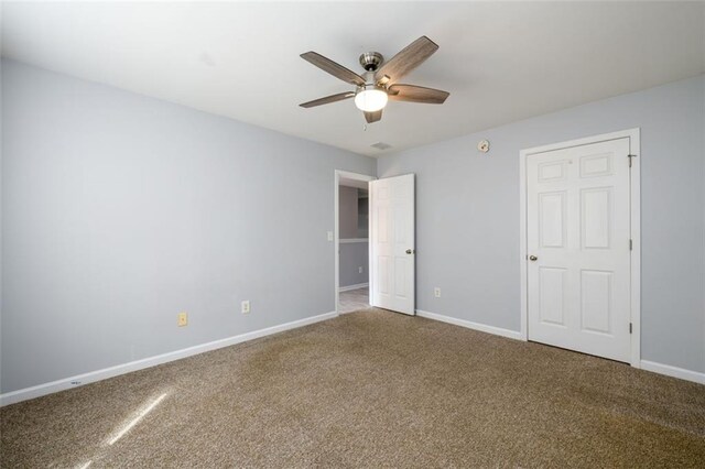 unfurnished bedroom with ceiling fan and carpet flooring