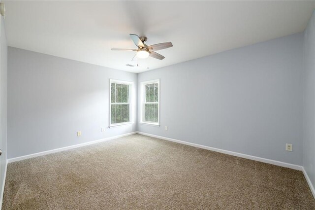 spare room with carpet and ceiling fan