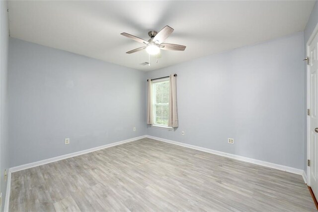 unfurnished room with light wood-type flooring and ceiling fan