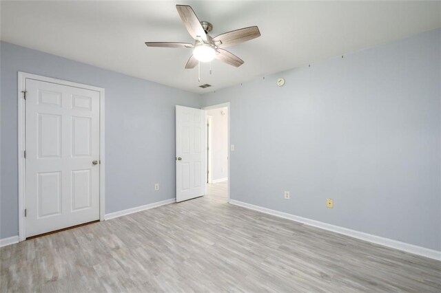 spare room with light hardwood / wood-style floors and ceiling fan