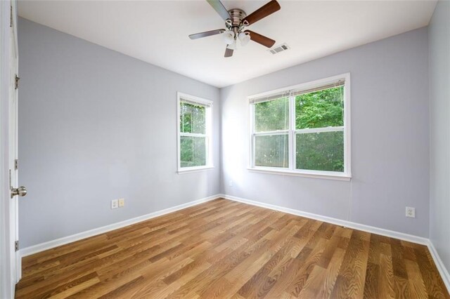 spare room with ceiling fan and hardwood / wood-style flooring