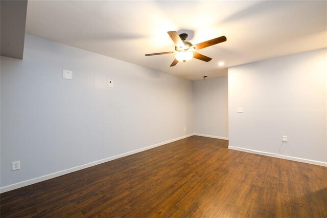 spare room with ceiling fan and dark hardwood / wood-style floors