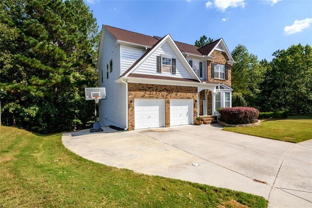 view of front of property featuring a garage and a front lawn