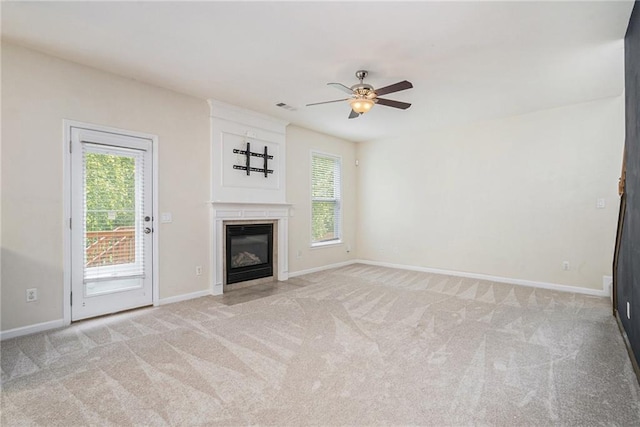 157 Spur Ln, Hiram, GA 30141 - unfurnished living room featuring a ceiling fan, light colored carpet, a glass covered fireplace, and baseboards